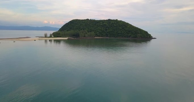 Drone fast flight at low attitude above calm water at the uninhabited island ko Tae Nai, Near koh Phangan island, Thailand
