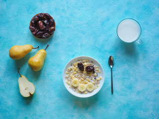 Milk and granola. Traditional european breakfast. Muesli, dates and fresh pears