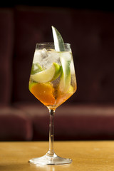 Cocktail with apple and ice cubes in glass 