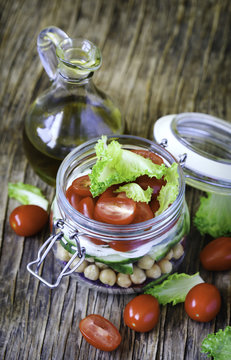 Healthy vegetable and chickpea sprout vegan salad in glass jar. Healthy food concept.