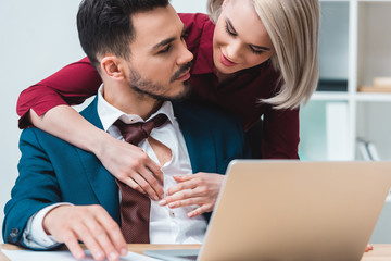 beautiful young business colleagues flirting while working together in office