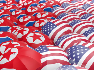 Fototapeta premium Flags of North Korea and US on umbrellas