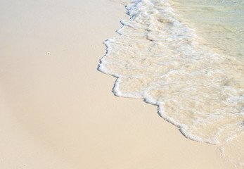 Sea beach with smooth wave photo background. Coral beach sand with sea tide.