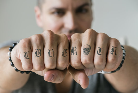 Closeup of knucle tattoos of a man