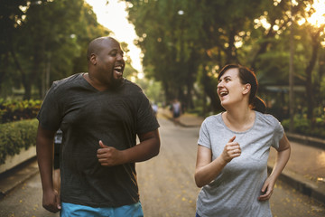 Man and woman running in park