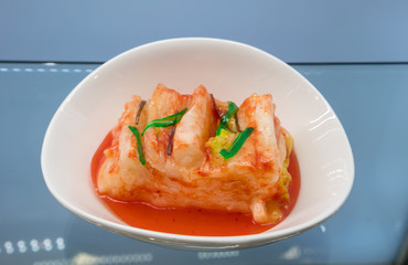 A closeup look through cabinet mirror of Japanese kimchi model
