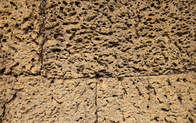 Rough stone ancient wall closeup photo. Stone wall texture. Rustic stone wall of ancient building.