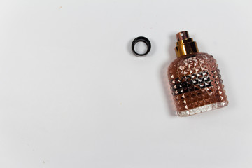 Bottle of perfume isolated on white background. top view.