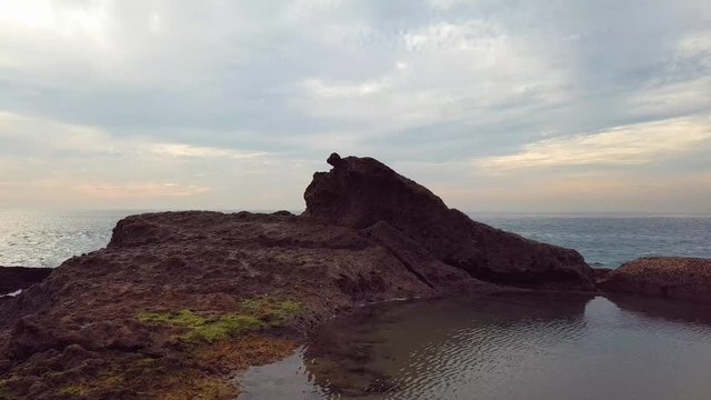 Beach Rocks dolly in zoom in drone shot