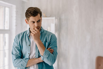 Obraz premium Thoughtful young man wearing lounge wear clothes at home