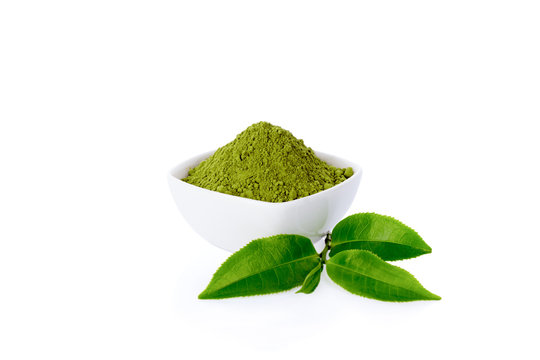 Powder green tea and green tea leaf isolated on white.
