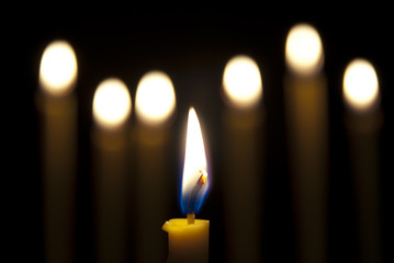 burning candle isolated on black background