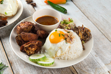 malaysian fried chicken rice with anchovies and egg