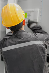 Fototapeta premium Engineer commissioning bay control unit. Engineering department