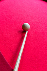 Billiard balls on the red baize of a billiard table.