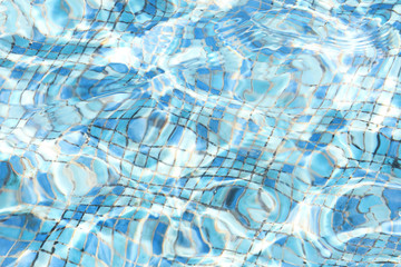 Beautiful transparent blue water texture and a bottom of the fountain.