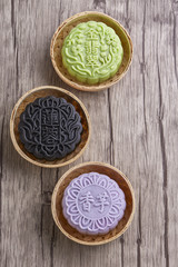 Chinese mid autumn festival foods. Snow skin mooncake on wooden table with text Green 