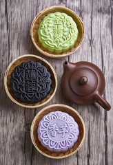 Chinese mid autumn festival foods. Snow skin mooncake on wooden table with text Green 