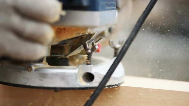 Man working with a router - slow motion close up