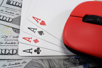 casino online, real money. on the table money (dollars), playing cards, and mouse from the computer