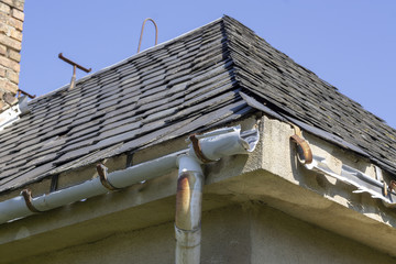 Broken guttering on the roof of a house