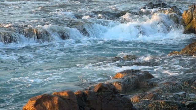 4k movie of Wonderful seascape at Nui Chua national park, Ninh Thuan, Viet Nam, waves on large rock and make amazing fall in Hang Rai at sunrise