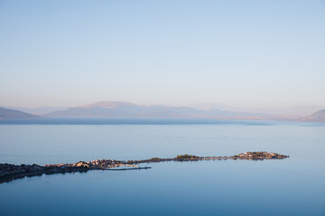 aerial view of majestic landscape with calm blue water and mountains in fog, egirdir, turkey