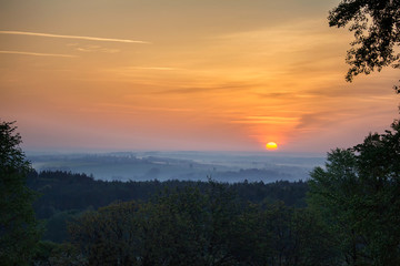 Fototapeta na wymiar Sunrise over tree and mysty fog. Czech landscape