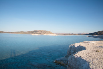 scenic view of white limestone on shore of beautiful calm lake, salda golu, turkey
