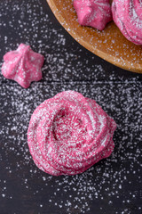 Close-up meringues on dark wooden background
