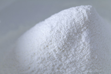 Closeup of a pile of white all-purpose wheat flour isolated with copy space