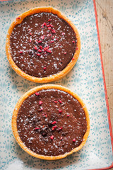Raspberry and chocolate fondant tart. All butter pastry tart with chocolate filling and raspberry compote centre, finished with raspberry & chocolate crumble.