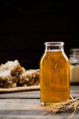 Linden honey in a transparent glass bottle