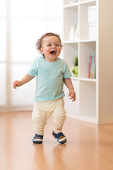 Little baby boy running and laughing in ther living room