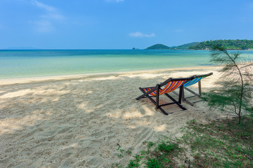 Fototapeta na wymiar Beach chairs on the white sand beach and tropical sea in Thailand.