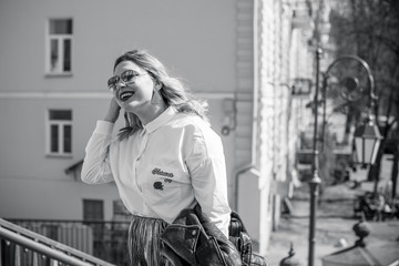 Happy smiling fashionable plus size young woman in modern city life. Life of xl lady. Concept of positive lifestyle. Pretty stylish girl at city center 
