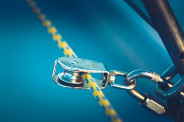 The rigging block with swivel and yellow rope. Part of the rigging of the yacht. Close up.