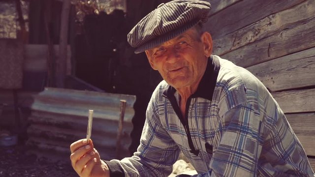 Farmer smoking a cigarette on the farm , straw cigarette