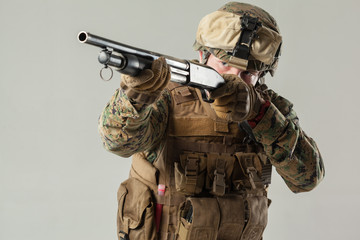 Fototapeta premium Soldier in camouflage holding rifle