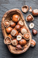 Filberts or hazelnuts in the wooden bowl on the table.