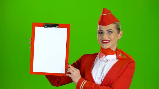 Stewardess raises a red folder with a white sheet of paper. Green screen