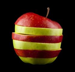 Fototapeta na wymiar cut red and green apple on a black background