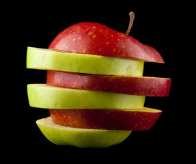 Fototapeta na wymiar cut red and green apple on a black background