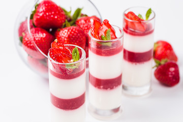 Strawberry Panna Cotta on a white background (close)