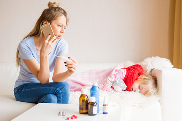 Mom of sick child calling doctor on phone