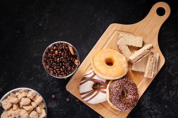 Top view of different type of sweets and pastry on dark vintage wooden background