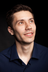 Obraz premium Fashion portrat of young man on black background in studio photo