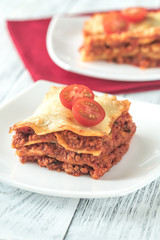 Portion of lasagne on the white plate