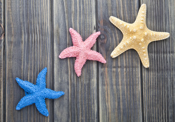 Fototapeta na wymiar sea stars on a wooden background