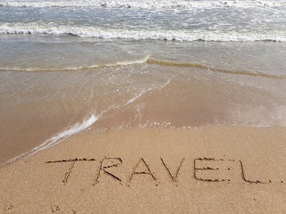 the word travel written on the sand, nobody.